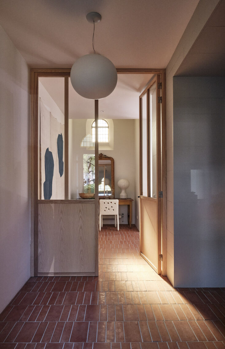 architectural wood doors with windows lead into a hallway and downstairs bedroo 24
