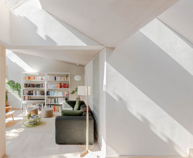 the living room benefits from a series of angled skylights and windows that loo 22