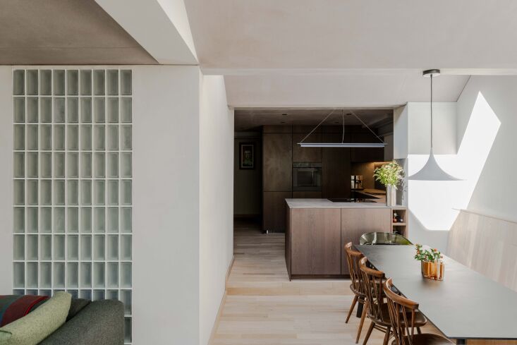 a view into the kitchen shows the intentional contrast of light and dark spaces. 23