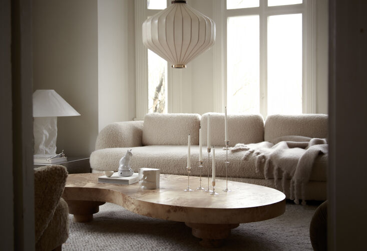 the living room is anchored with the low mung coffee table in burl wood topped  22