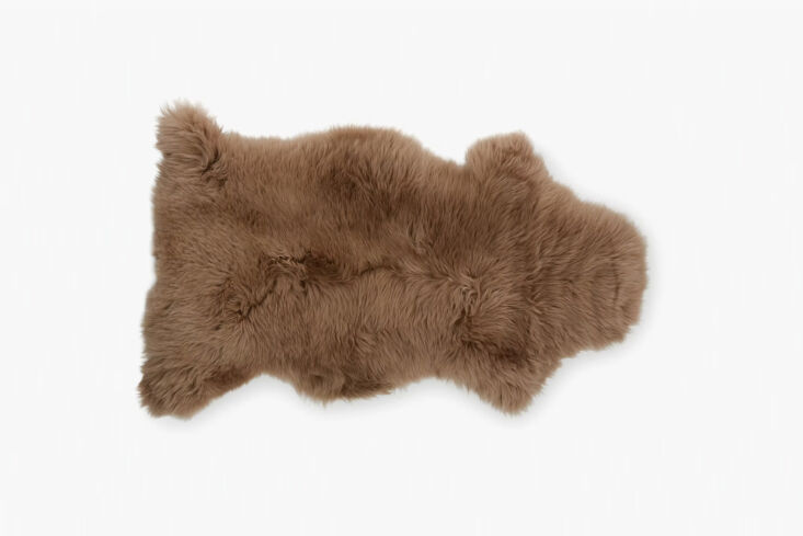 the sheepskin throw in brown is on sale for \$87 at dwr. 28