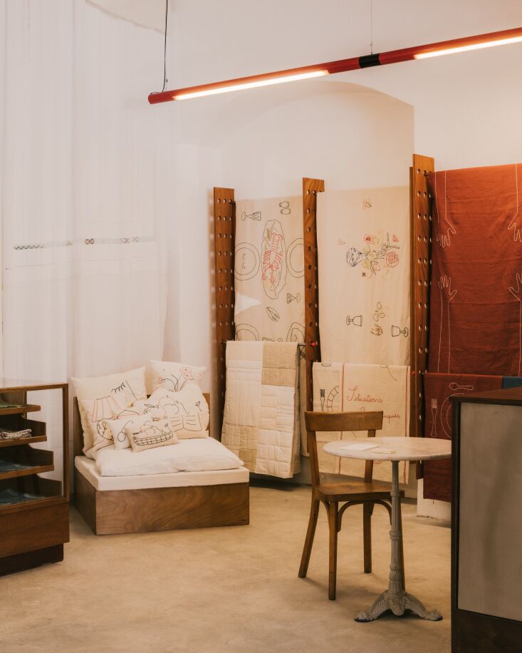 a pegboard like hang rack displays trompe l\2\17;œil tablecloths and be 23