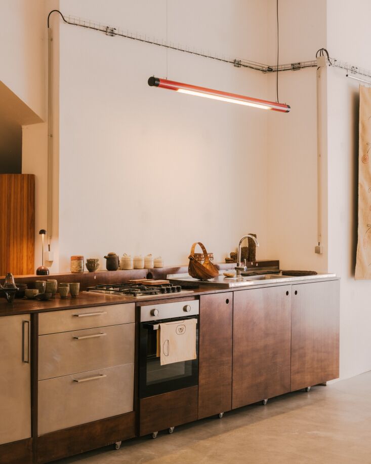 the kitchen is a feat of diy. designed and custom built for her former showroom 21