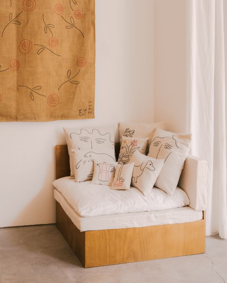 a custom built plywood corner chair is fitted with an array of cushions depicti 19