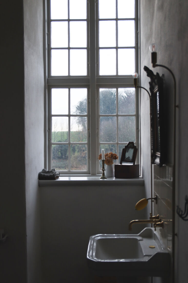 the bath adjacent to monastery rooms is fitted with traditional fixtures and a  23