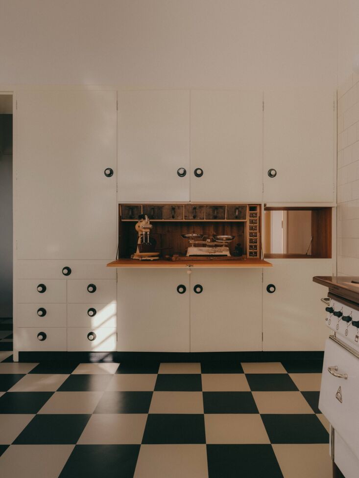 the characterful black and white kitchen features a fold out table with aluminu 26