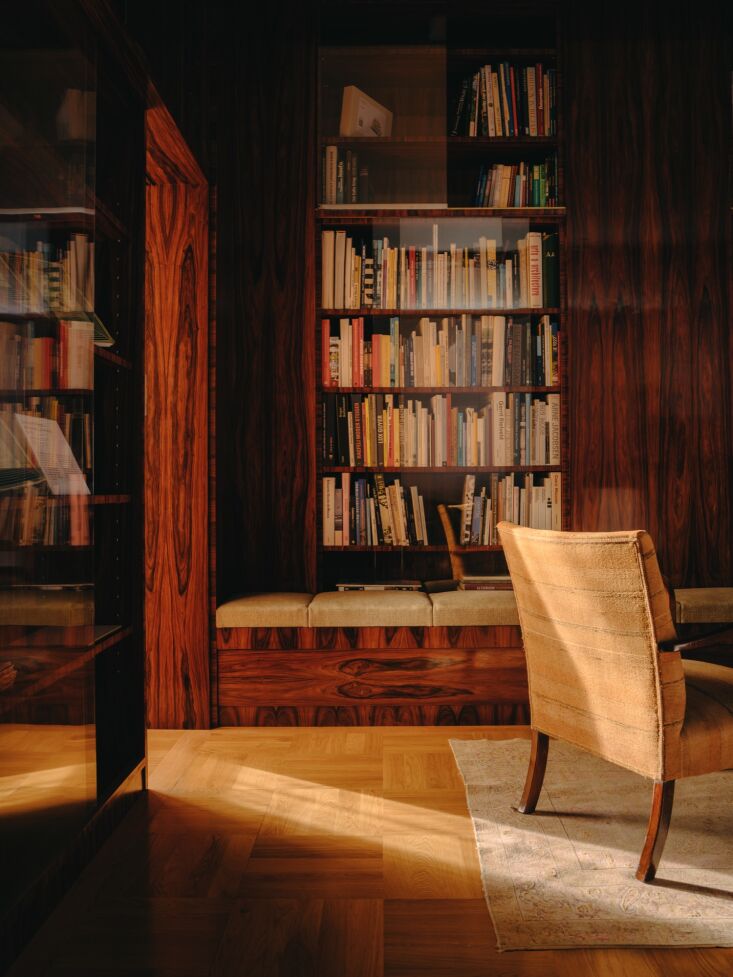 glass front bookshelves and oak parquet floors. 19