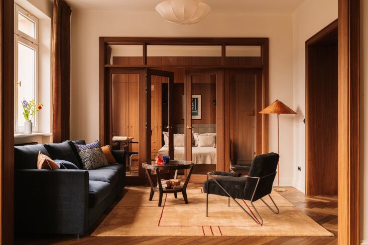 anchoring the center of the apartment is the living room, which is open to both 24