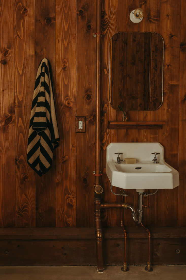 in the bathroom, the walls are tongue and groove cedar, and the sink came from 25