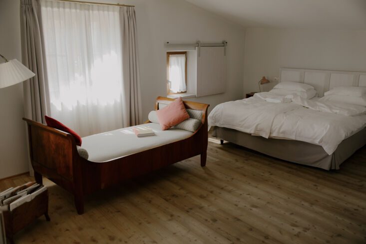 a antique daybed pairs with characterful velvet cushions. small windows were fi 23