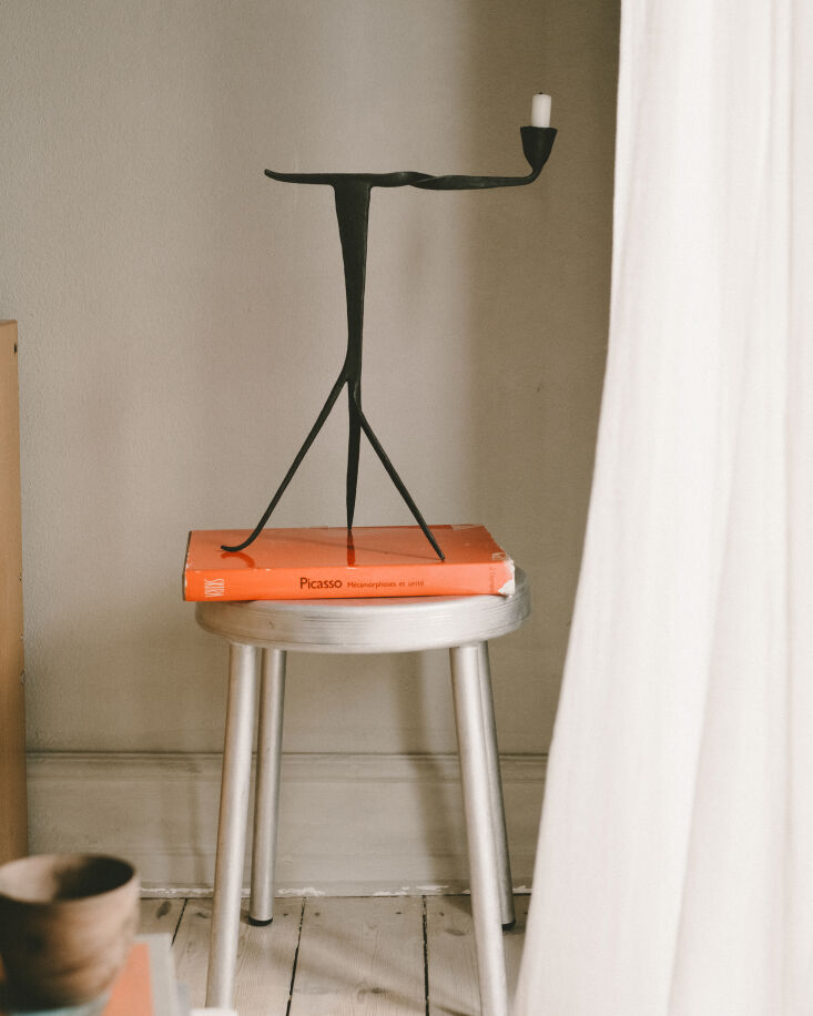 on the frama tasca aluminum stool stands a book on picasso and the campanula ca 27