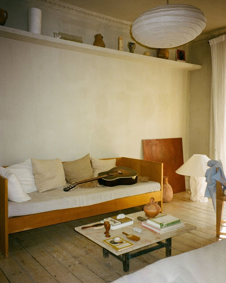 in the living area, fred and kasia built a shelf that extends the length of the 22