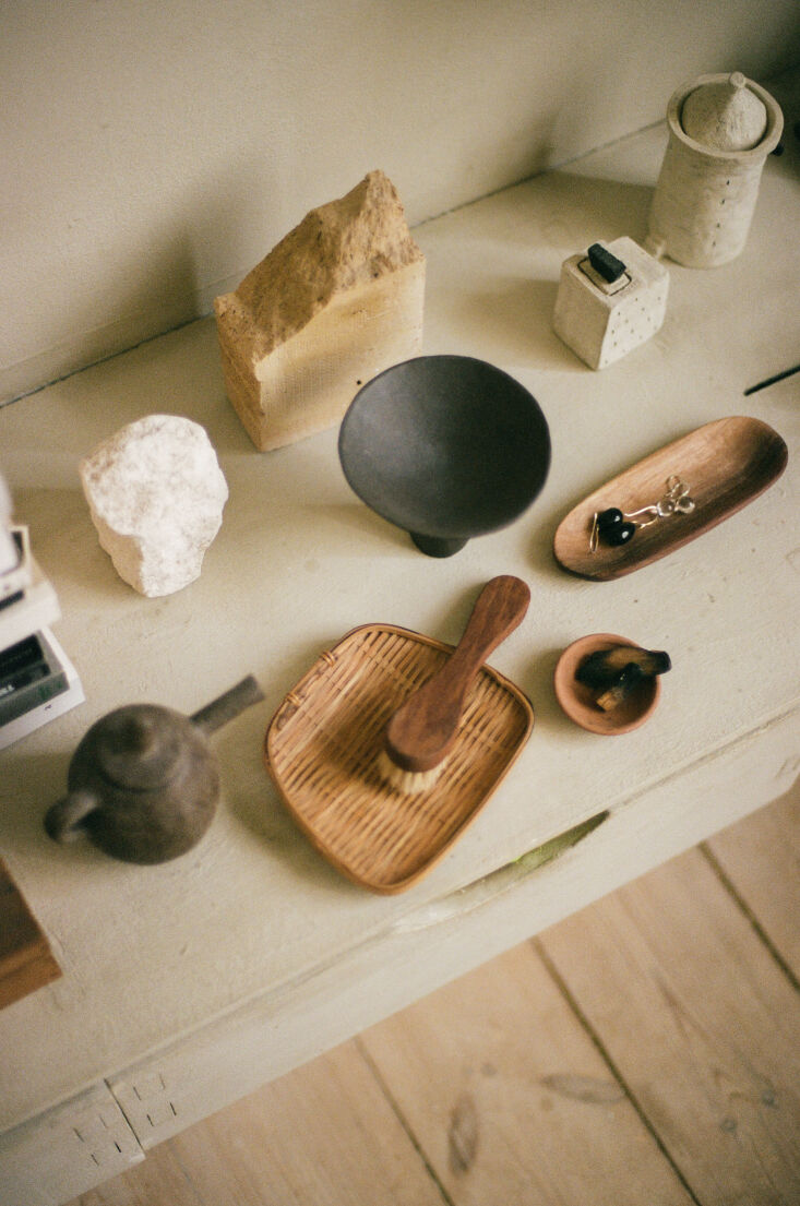 a collection of smaller pieces in stone, bamboo, ceramic, and wood. both kasia  23