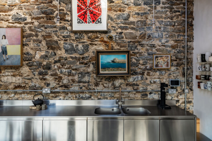 a row of stainless steel cabinets make up the kitchen. (see kitchen(s) of the 19