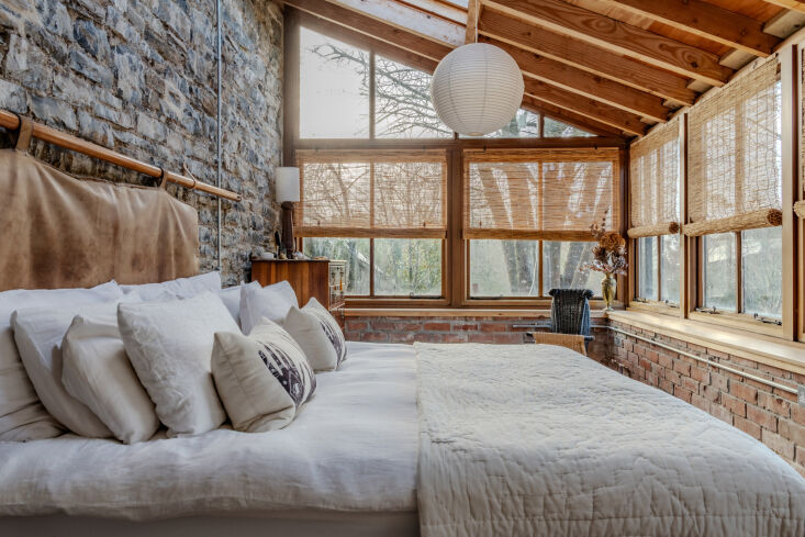 the simple bedroom. much of the home was built using local stone and brick. for 25
