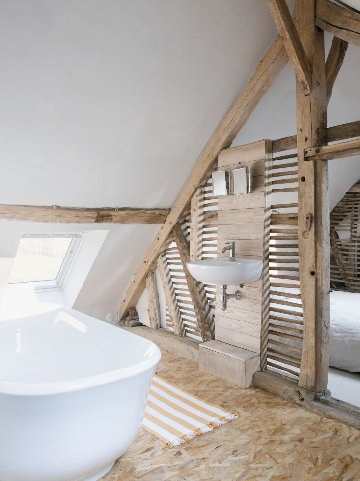 an ash wood built in wall houses a basic wash basin. 28