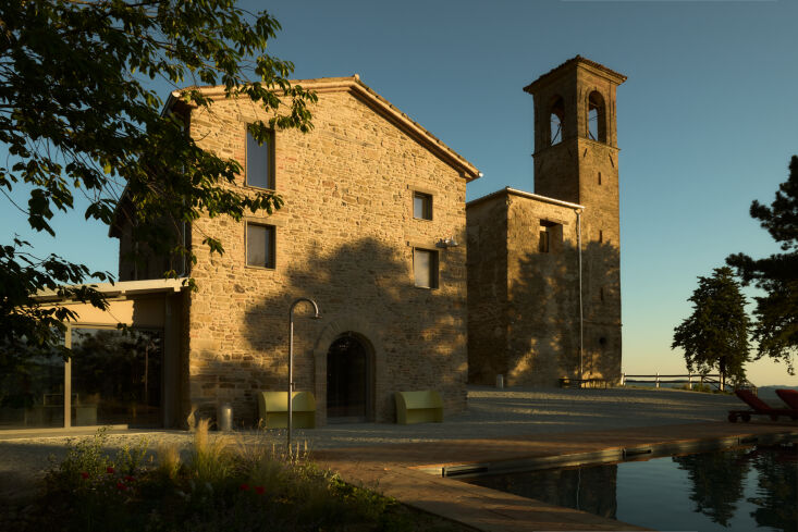 outside of the locanda scavolo is the scavolo pool, an arch shaped pool with a 28