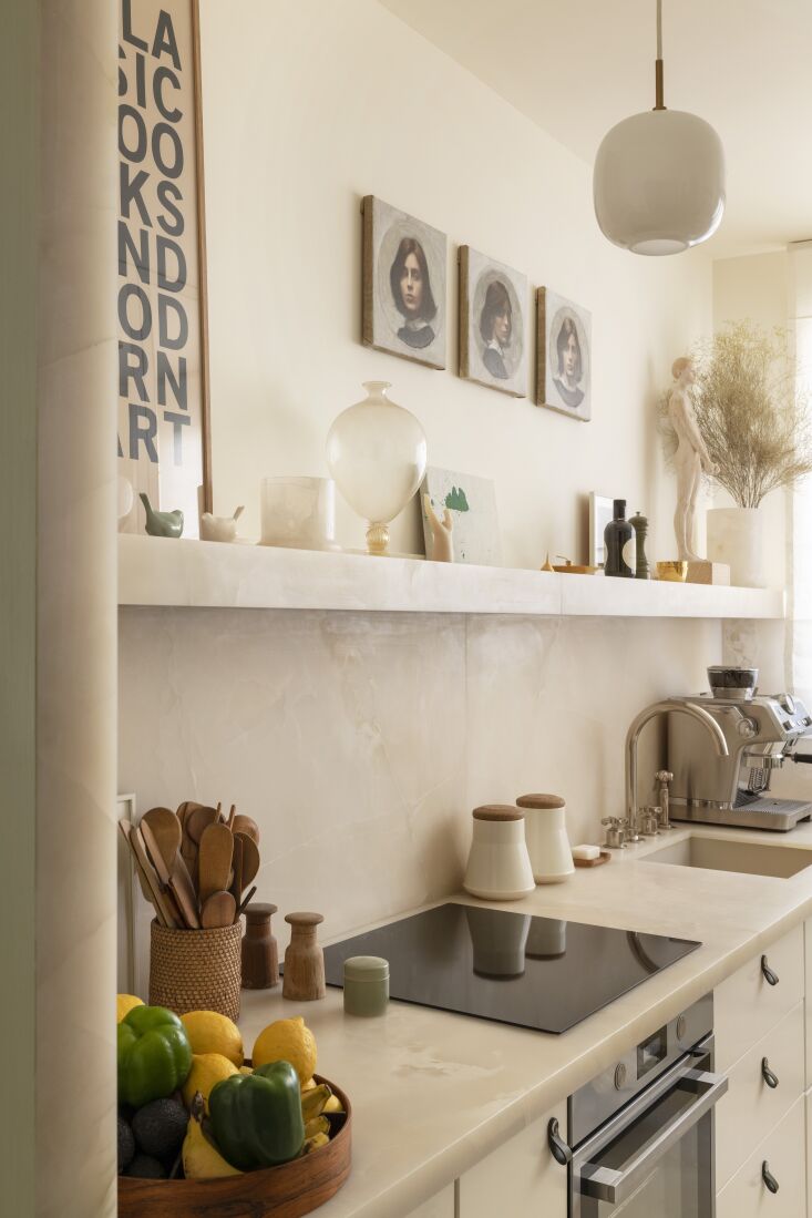 the kitchen is designed in soft white onyx with a waterworks faucet. 26