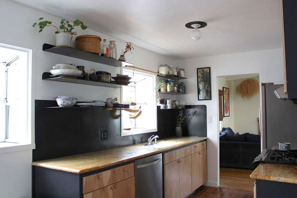galley kitchen with blackened steel backsplash and open shelves 8