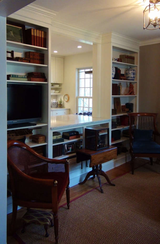 the built ins hide the refrigerator and range from view in the sitting room. 13