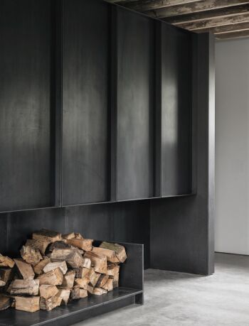 brick barns black metal fireplace with concrete flooring by mclaren excell